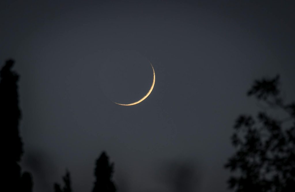 thin crescent moon in the sky